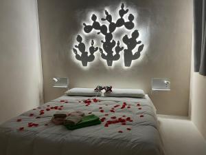 a bedroom with a bed with red roses on it at Casa Mediterranea Jacuzzi riscaldata con Caminetto in Specchiolla +37 photos