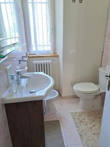 a bathroom with a sink and a toilet at Casa Vitiolo 