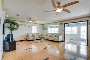 a living room with a couch and a ceiling fan at Waterfront Galveston Bay Retreat - 4 Mi to Beach! in Galveston