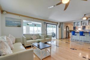 a living room with a couch and a table at Waterfront Galveston Bay Retreat - 4 Mi to Beach! in Galveston