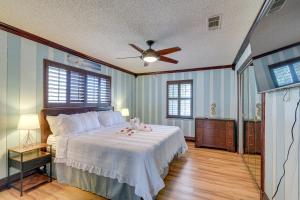 a bedroom with a bed and a ceiling fan at Waterfront Galveston Bay Retreat - 4 Mi to Beach! in Galveston