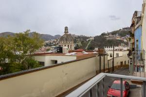 a view of a city from the balcony of a building at Hotel La Colección, Universidad de Guanajuato, Centro in Guanajuato