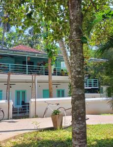 a bike parked in front of a house at Molly's Hostel in Varkala