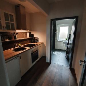 a small kitchen with a sink and a bathroom at Ferienapartment Lilo in Eisenhüttenstadt