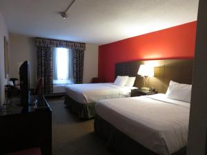 a hotel room with two beds and a window at American Inn & Suites in Ferndale