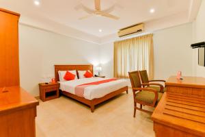 Vembanad Tourist Home tesisinde bir odada yatak veya yataklar