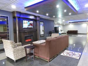 a living room with a couch and a fireplace at American Inn & Suites in Ferndale