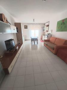 un soggiorno con divano e tavolo di casa fronte mare ad Alba Adriatica