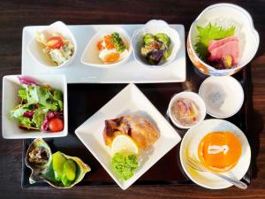 a tray with plates of food on a table at Ducale Gran Resort 99 - Vacation STAY 00092v in Kujukuri