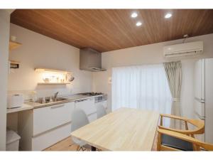 a kitchen with a wooden table and a dining room at KONOHANA NO IORI - Vacation STAY 15340v in Mimasaka
