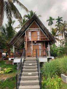 a house with stairs leading up to it at Steps Garden Resort in Negombo