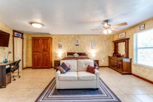 a bedroom with a couch and a bed in a room at Hide Away Guest House in Azle