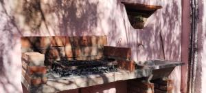 a kitchen with a brick fireplace in a room at La Calabaza Cabaña in Tilcara
