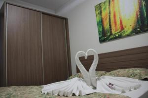 a swan made out of towels sitting on a bed at Veredas do Rio Quente Hotel Service in Rio Quente