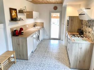 a kitchen with a sink and a stove at Logement classé 4 étoiles avec SAUNA et vue sur le Canigou in Fuilla