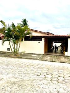 a building with a palm tree in front of it at Casa de temporada en prado in Prado