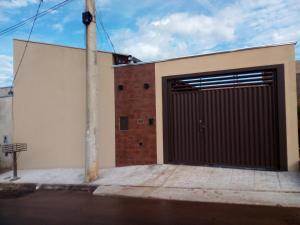 a building with a large garage door on a street at Aconchego da canastra in Delfinópolis