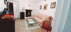 a living room with a couch and a table at Casa Lale in Corchiano