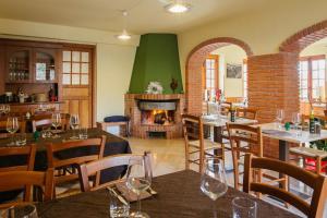 a restaurant with tables and chairs and a fireplace at Terrematte turismo e natura in Polizzi Generosa