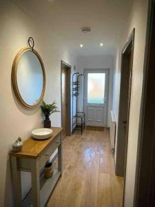 a bathroom with a sink and a mirror on the wall at Modern Coastal 2 Bedroom Home to Relax and Unwind in Heacham