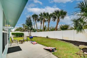 a patio with a fence and a yard with chairs at Ormond Beach Vacation Rental - Walk to Ocean! in Ormond Beach