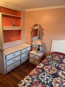 a bedroom with a bed and a dresser and a mirror at ELIS APARTMENT in Ocean City