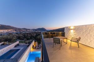 a balcony with a table and chairs on a house at Luxurios Private Summerhouse by Renovu in Kalkan