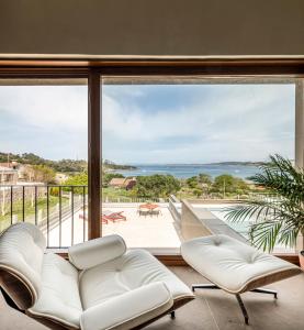 a living room with a view of the ocean at INSUA BEACH HOUSE in Pontevedra