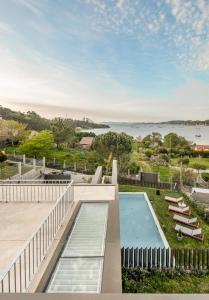 a view of the water from the balcony of a house at INSUA BEACH HOUSE in Pontevedra