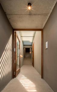 a hallway with a ceiling fan and a hallway with stairs at INSUA BEACH HOUSE in Pontevedra