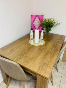 a wooden table with two candles and flowers on it at Jimmy's Crib in Moudhros