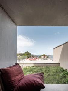 a pillow sitting on a porch with a view of a patio at INSUA BEACH HOUSE in Pontevedra