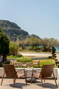a patio with two chairs and a table with a view at Plakias Suites COCO-MAT Full Experience in Plakias
