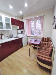 a small kitchen with a table and a couch in it at Квартира на Пентагоне in Bender