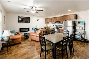 a kitchen and living room with a table and a couch at Family-friendly Suite with HotTub MemoryBeds SmartTV in Vineyard