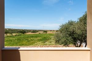 uma janela com vista para um campo verde em Villa Menorca Flomertor 2 by Mauter Villas em Cala en Blanes