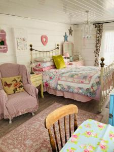 a childs bedroom with a bed and a chair at Shabby Shack near Charlestown & The Eden Project in St Austell