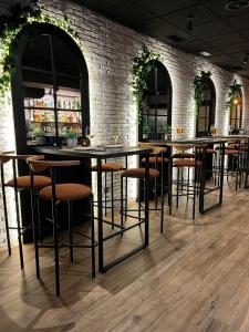 a row of bar stools in a room with a brick wall at Pensión Quilmes in Vimianzo
