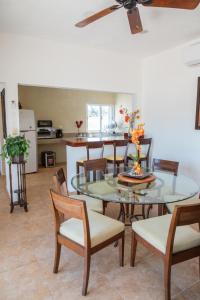 a dining room with a glass table and chairs at Departamento con alberca privada in Chetumal