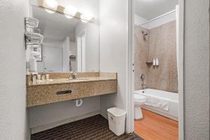 a bathroom with a sink and a toilet and a mirror at Heritage Inn Express Hayward in Hayward +36 photos