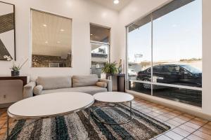 a living room with a couch and a table at Heritage Inn Express Hayward in Hayward