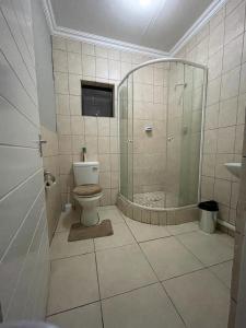 a bathroom with a shower and a toilet at Yello guest house in Vanderbijlpark