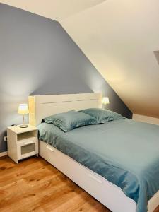 a bedroom with a large bed with a white headboard at Ruheoase - Premium Suite in Karlsruhe
