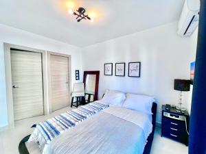a bedroom with a bed and a table and chairs at Punta cana one bedroom apartment residencial Crisfer 17A apartamento 405 in Punta Cana