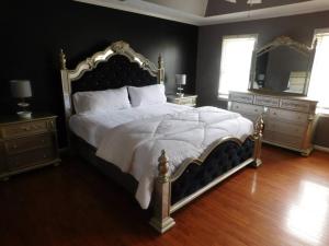 a bedroom with a large bed with a white comforter at Stone Mountain Cozy Home in Snellville
