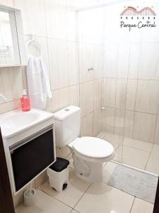 a bathroom with a toilet and a sink and a shower at Pousada Parque Central in Penha