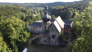 an old church in the middle of a forest at Maringotka na samotě na kozí farmě in Poběžovice