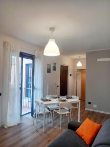 a living room with a table and chairs and a couch at Da Sandro Holidays Apartment in Arco
