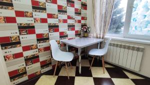 a dining room with a table and two chairs at Квартира в центре Бендер in Bender +8 photos