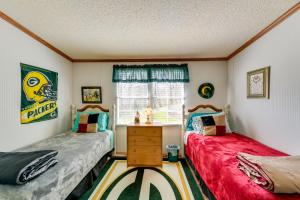 two twin beds in a room with a window at Hot Tub, Fire Pit and Views Balsam Grove Getaway in Balsam Grove